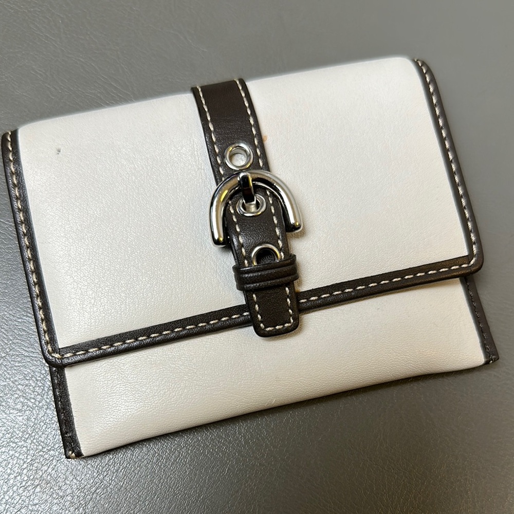 Coach white leather small wallet with brown leather buckle belt.
